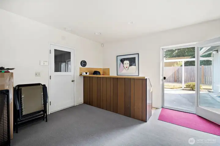 Enjoy this Great room with partial wet bar!  Patio door to backyard.  Left door leads to garage