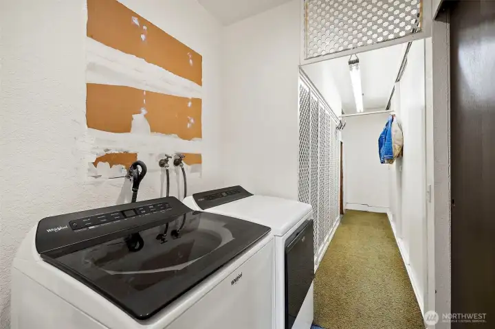 Both sides beyond washer/dryer are oversized storage closets