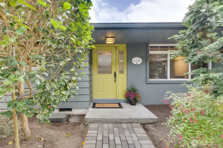 Welcoming entry with a custom front door with rain glass.