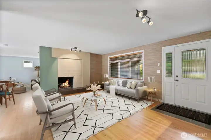 Cozy evenings by the fire in a warm, welcoming living space. Inviting living room with fireplace and open layout.
