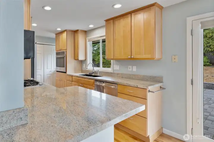 Updated kitchen with granite counters, stainless appliances, and ample storage.