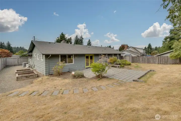 View of backyard - side yard has raised garden beds. Storage shed and separate custom garden shed.