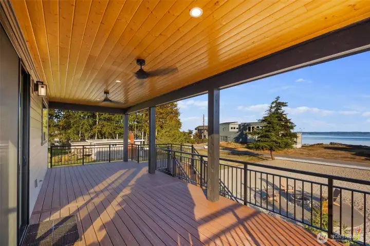 Big finished deck on the front side of home, overlooking patio.