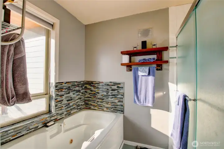 Main floor primary with jetted tub.