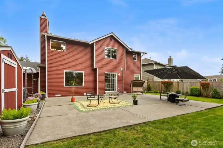 Fully fenced backyard with side garden area and shed