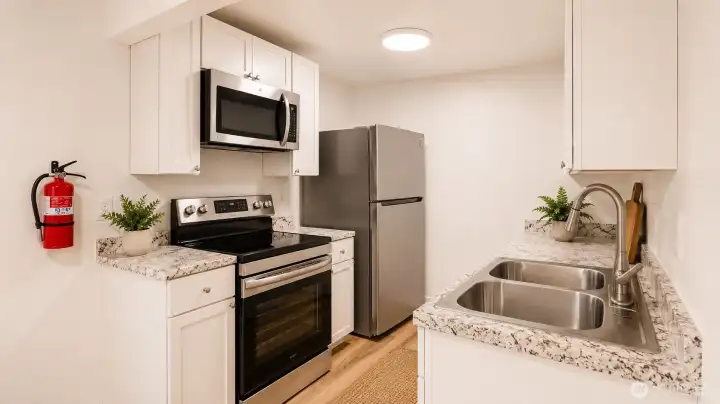 Virtually Staged updated cabinets with nice appliances