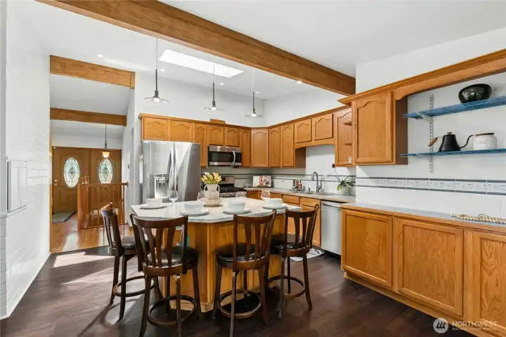Functional kitchen layout with island seating and ample workspace. Functional kitchen layout with island seating and ample workspace.