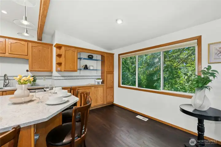 Sunlit breakfast area overlooking the private backyard. Sunlit breakfast area overlooking the private backyard.