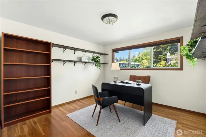 Versatile room with custom built-ins ideal for work or study. Versatile room with custom built-ins ideal for work or study.