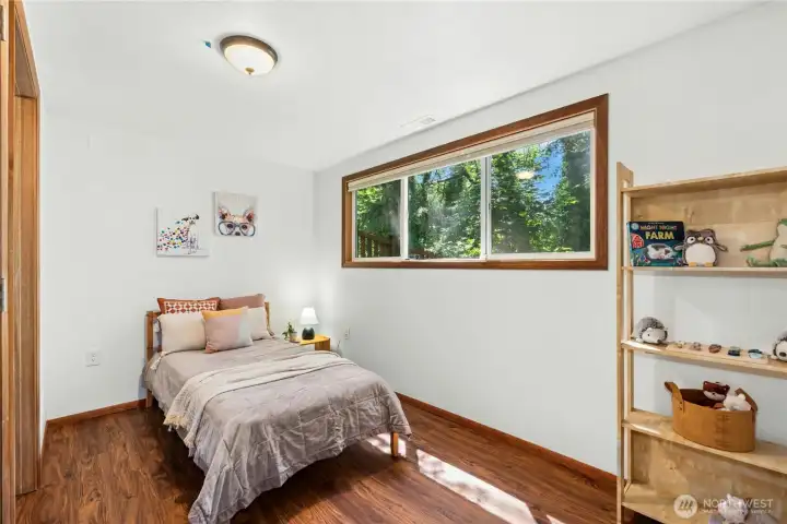 Comfortable bedroom with peaceful backyard views. Comfortable bedroom with peaceful backyard views.
