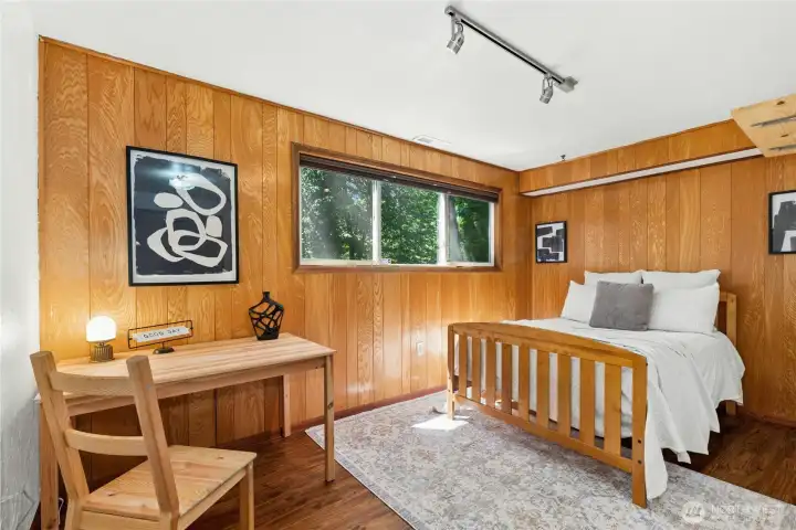 Charming wood-paneled room with a cozy cabin-inspired feel. Charming wood-paneled room with a cozy cabin-inspired feel.