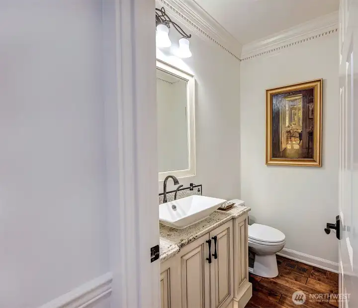 Your guests will love this elegant main floor powder room with vessel sink. Your guests will love this elegant main floor powder room with vessel sink.