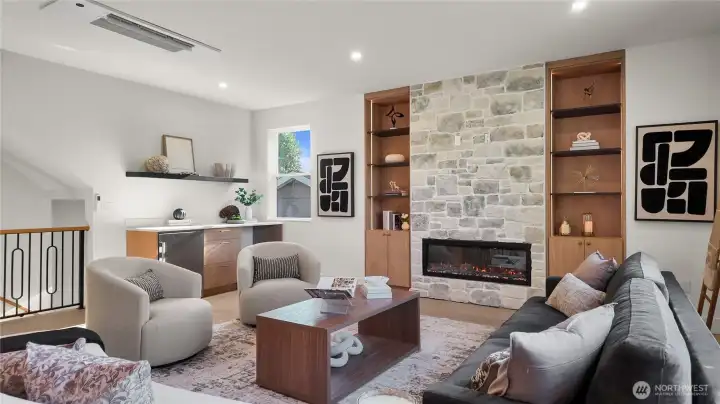 The living room boasts a fireplace and a dry bar with wine fridge The living room boasts a fireplace and a dry bar with wine fridge