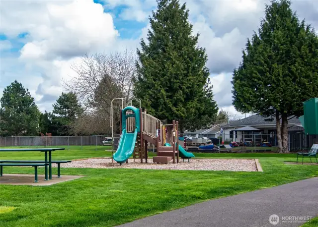 Playground in the neighborhood.  To the right is a basketball hoop.