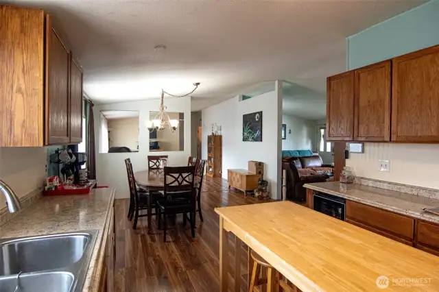Kitchen opens to dining room.  Island stays. Double stainless sink.