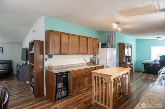 Kitchen features lots of cabinets and counter space. Room for a wine fridge.  To the right is the second dining area.  Laundry room leads to back yard.