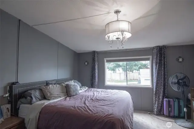 Primary bedroom with vaulted ceilings and full bath.