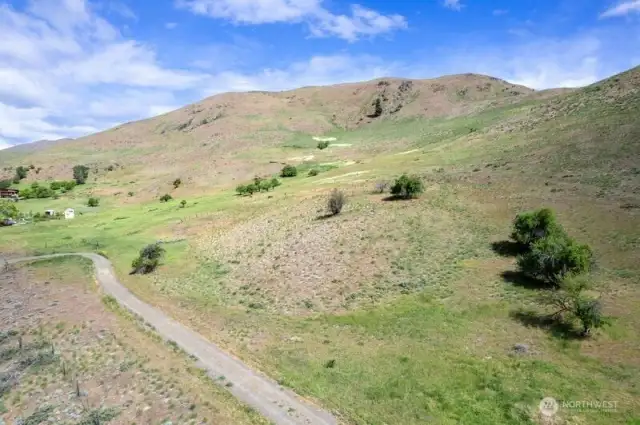 Simple dirt gravel driveway takes you on the property and shared with neighbor beyond the 7.33 Acres to the East.