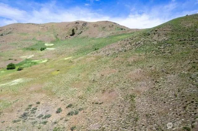 Hugged by rugged hillsides bordering this Land.