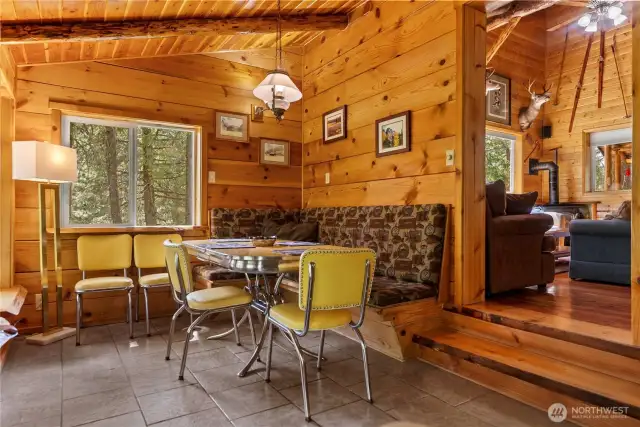 Enter into the radiant floor heated sunken dining room with wrap around windows- if you want to be surrounded by woodsy views from the comfort of your own indoor table.