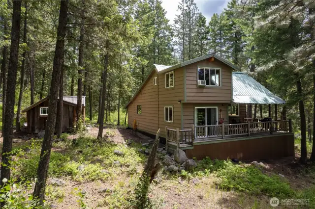 See the wrap around deck from this angle, covered front porch, and outdoor sauna.  What you don't see are neighbors!