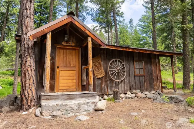 Freestanding sauna with electric powered sauna heater, changing room, and storage area for seasonal gear around the other side.