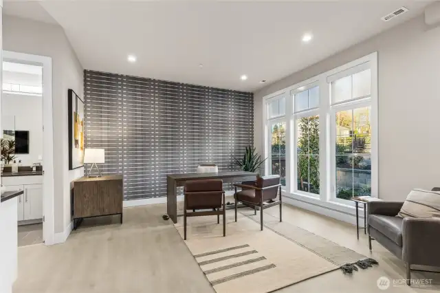 Main floor home office or bedroom w/ en suite bath & walk in closet.