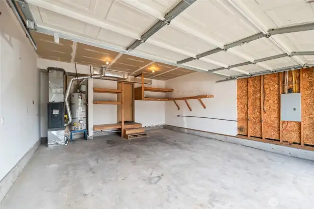 Good size garage with newer water heater and furnace and shelving!