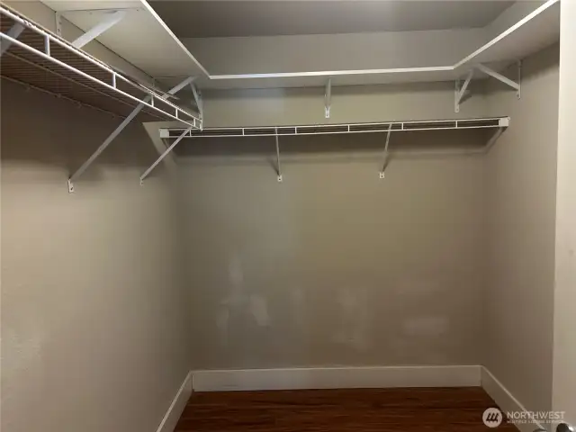 Large walk-in closet with overhead shelves