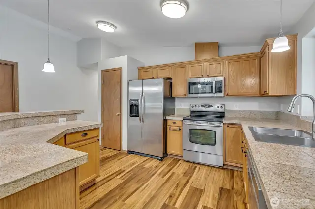 Open island kitchen with stainless steel appliances