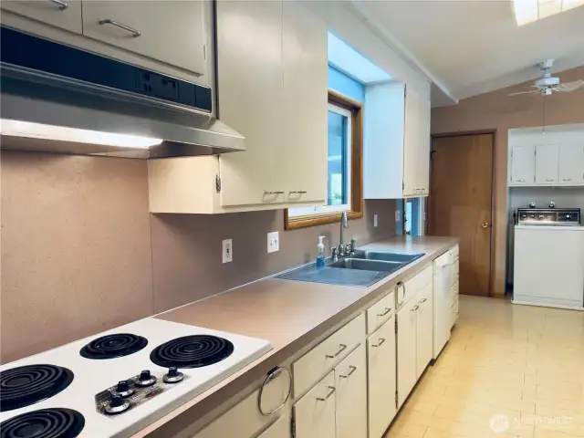 Spacious kitchen, walk-in pantry, all appliances stay with home, covered patio, vaulted ceilings, nod to midcentury modern, butcher-block countertop on peninsula