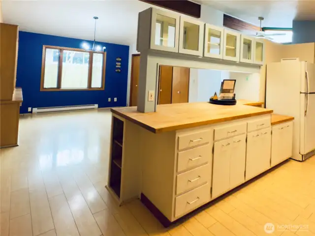 Kitchen has loads of storage with walk-in pantry, appliances stay with home, butcher-block countertop