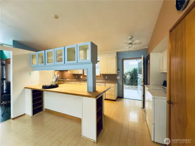 Open floor plan allows access to dining room and kitchen with back door to covered patio and fenced backyard with apple tree and garden area