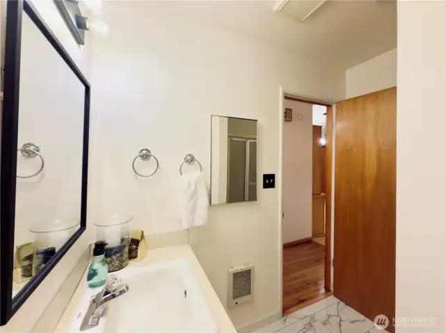 Main bathroom with new flooring: tub, shower, toilet and sink