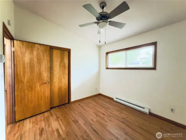 First bedroom, ceiling fan, vaulted ceiling, hardwood floor, move-in ready