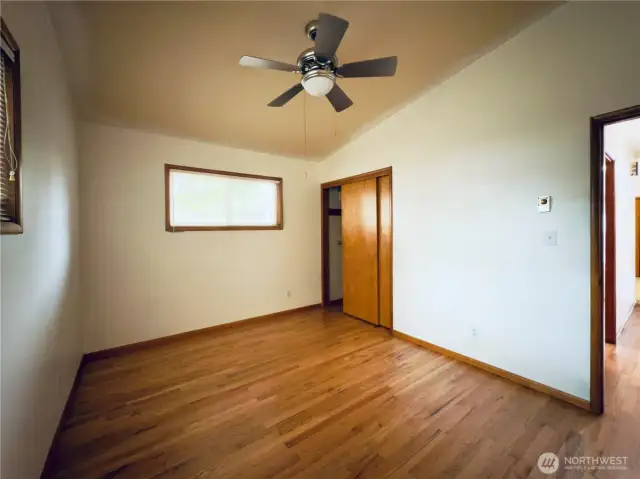 Second bedroom, ceiling fan, vaulted ceiling, hardwood floor, move-in ready
