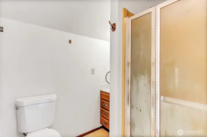 Bath with shower upstairs.