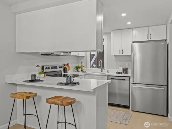 Brand new stainless steel appliances, quartz counters and soft-close cabinets give this spacious kitchen a warm and inviting feeling.