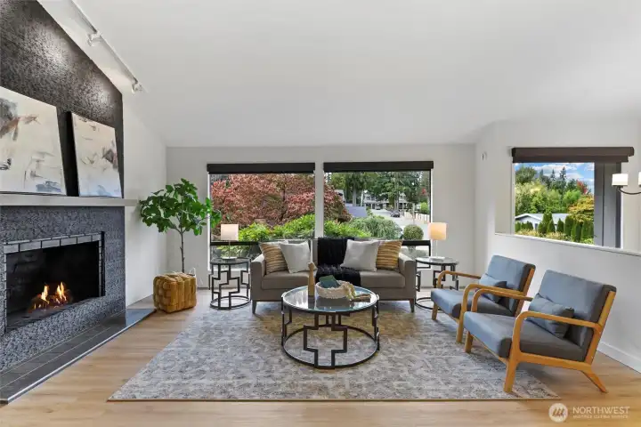 Great room with vaulted ceilings, wood burning fireplace, Lutron remote blinds