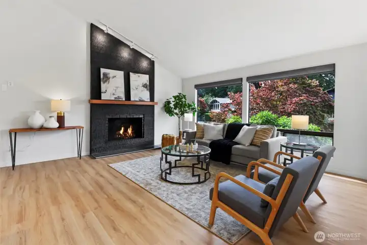 Great room with vaulted ceilings, wood burning fireplace, Lutron remote blinds