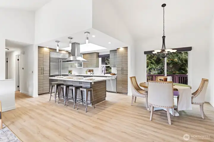 Great room with vaulted ceilings and open to chef inspired kitchen & dining area with professional appliances
