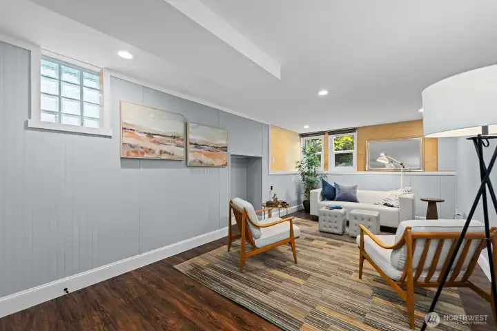 Stylish lower-level den with modern finishes, recessed lighting, and cozy lounge area—perfect for movie nights or casual gatherings. Egress windows and a small closet make this a legal 4th bedroom.