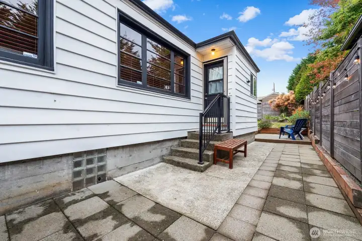 Private patio with string lighting and seating area—perfect for morning coffee, summer barbecues, or quiet evenings outdoors