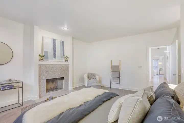 Cozy wood fireplace in the Primary suite.