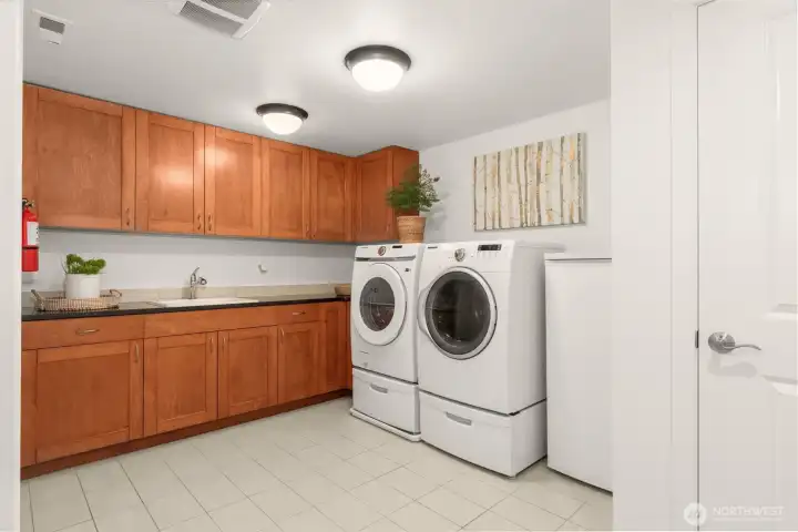 Laundry room has tons of storage space, including at closet at left that is not pictured.