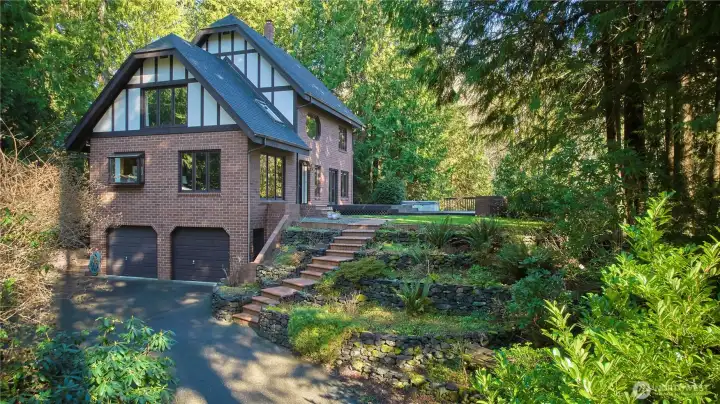 Front view of home. Gorgeous brick exterior and staircase. Very picturesque.