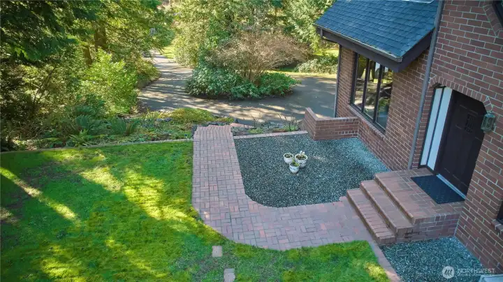 Brick walkway leading to front door. Front yard space.