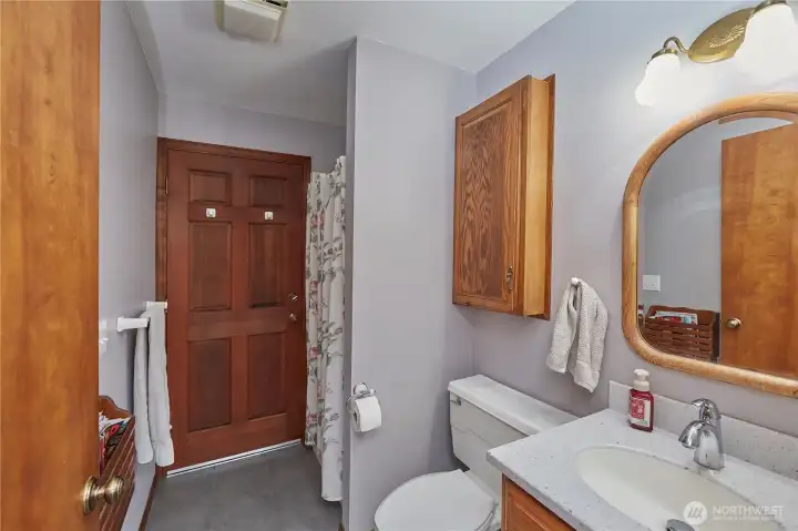 Main floor bathroom. There is a door within the bathroom that leads to the back deck for easy access into home after working outside.