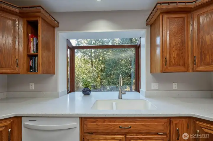 Kitchen window looks out over driveway and garage.