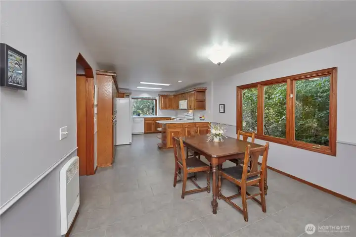 Dining room looking towards kitchen. Look at all this space. Wood windows looking out to the back of the home giving you that park-like view.